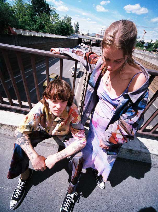 In voller Blüte_Image1 julia seemann flavio zimmermann two models man sitting woman standing road fence