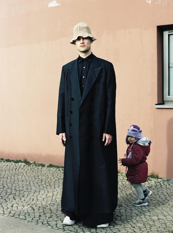 National Designer- Andra Dumitrascu is Romania2 Andra Dumitrascu Long black coat beige hat orange wall kid