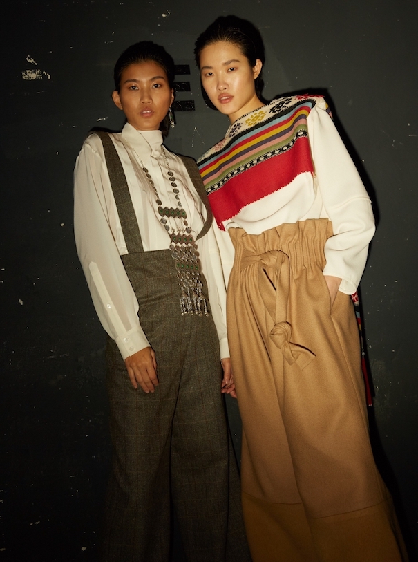 Nobieh Talaei_Image1 Nobieh Talei Campaign Two Models Pants Suit Sweater Red Brown Beige Black Background
