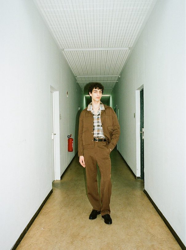 Sissi Goetze_Image3 Sissi Goetze Model Brown suit standing hallway campaign