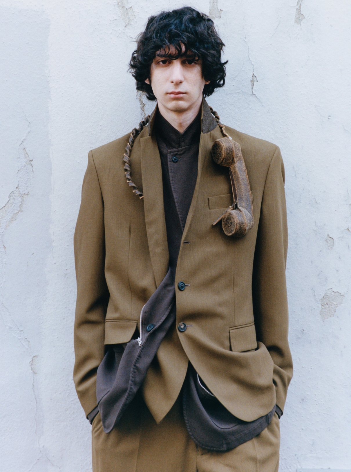 37 Male model wearing Suit TOD’S; Jacket COMME DES GARÇONS SHIRT; Phone accessory GAL NELL DAHAN