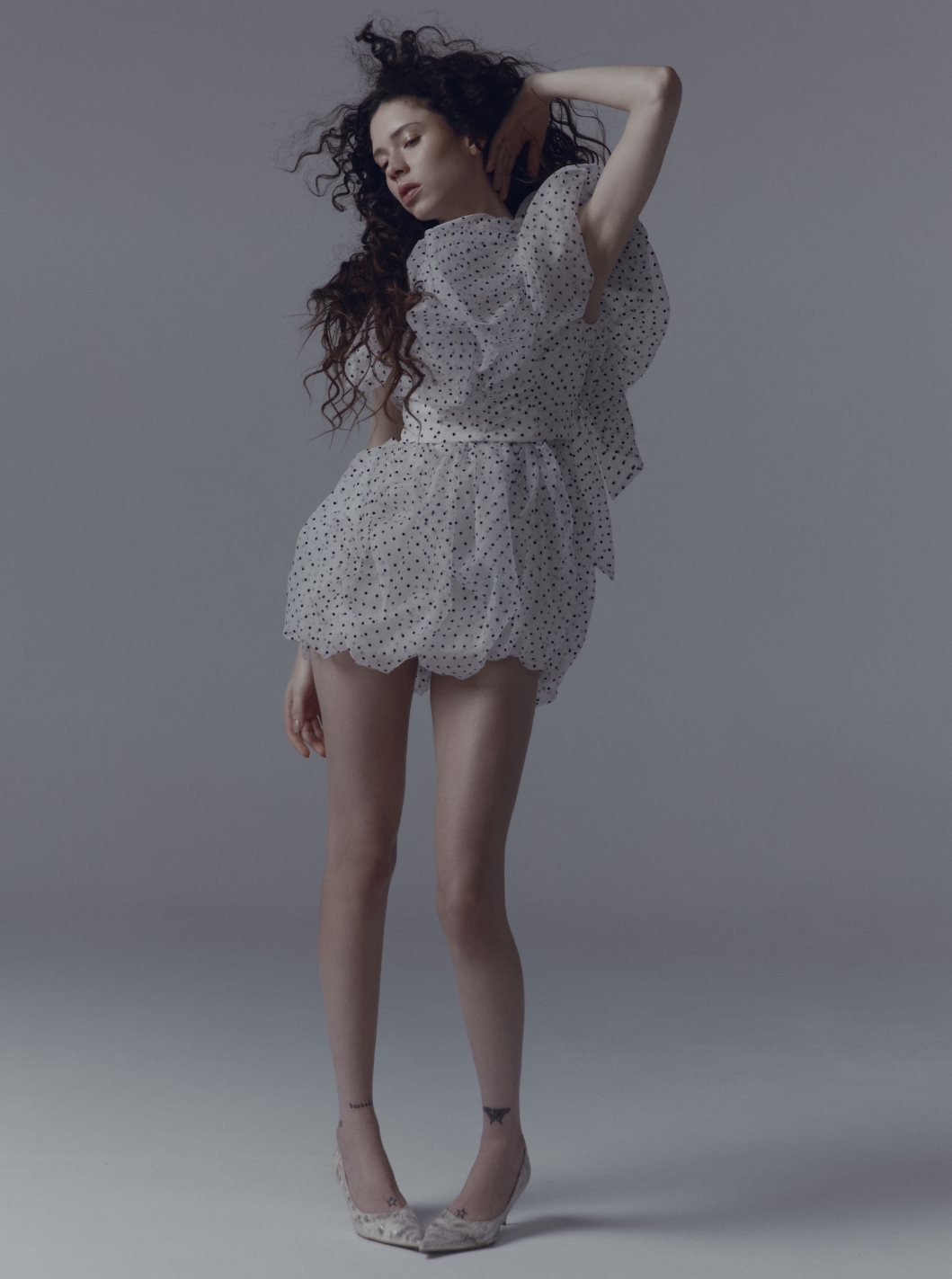 Model in candid shot wearing Top and skirt VIKTOR & ROLF; Shoes LOEWE