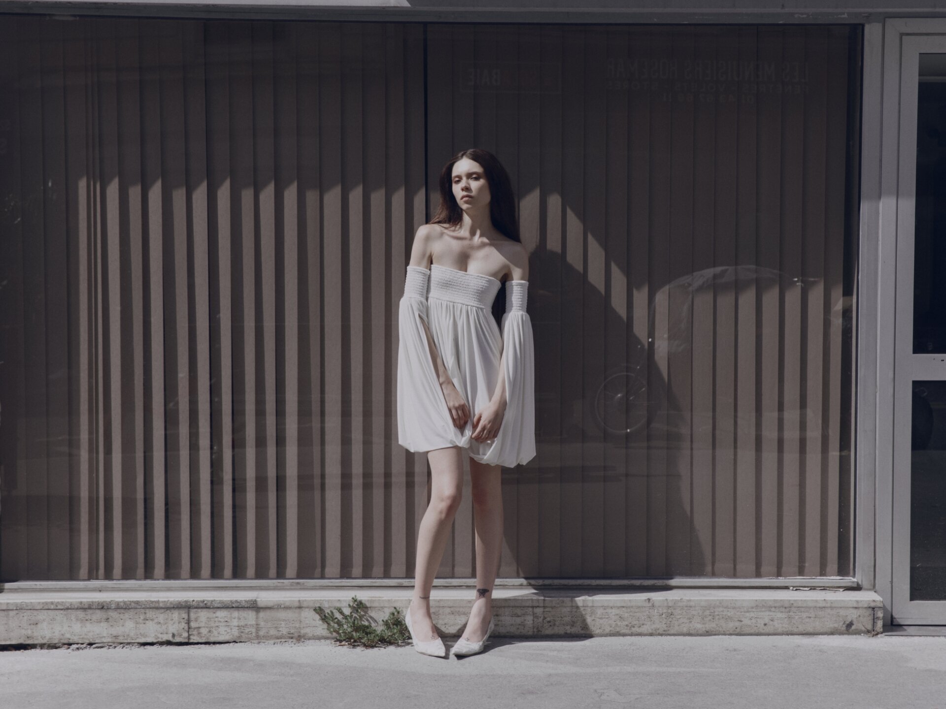 Model in candid shot wearing Dress COPERNI; Shoes PRADA